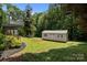 Lush backyard with a shed and trampoline surrounded by mature trees at 312 Walton Dr, Statesville, NC 28625