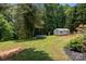 Sprawling backyard featuring a storage shed and trampoline at 312 Walton Dr, Statesville, NC 28625