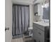 Neutrally-toned bathroom featuring a shower, toilet, and single sink vanity with storage at 312 Walton Dr, Statesville, NC 28625