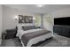 Comfortable bedroom with ample natural light, neutral decor, and stylish furnishings at 312 Walton Dr, Statesville, NC 28625