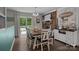 Cozy dining room with wood floors, brick fireplace, and natural light at 312 Walton Dr, Statesville, NC 28625
