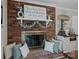 Living room fireplace with brick surround, decorative mantel, and comfortable seating at 312 Walton Dr, Statesville, NC 28625