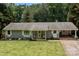 Charming single-story home with a well-manicured front yard, inviting entrance, and convenient carport at 312 Walton Dr, Statesville, NC 28625
