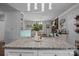 Open-concept kitchen with granite island, modern lighting, and view to dining area at 312 Walton Dr, Statesville, NC 28625