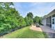 Inviting backyard featuring a brick patio, outdoor fire pit, and a tranquil wooded view at 317 Annatto Way, Tega Cay, SC 29708