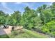 Serene backyard with a brick patio, outdoor fire pit, and lush trees, perfect for relaxation at 317 Annatto Way, Tega Cay, SC 29708