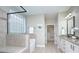 The primary bathroom boasts a tiled shower, soaker tub, and updated cabinets at 317 Annatto Way, Tega Cay, SC 29708
