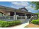 Community clubhouse with welcoming covered porch, stone detailing, and accessible entrance with steps at 317 Annatto Way, Tega Cay, SC 29708
