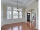 Formal dining room with hardwood floors, classic lighting, and elegant architectural details at 317 Annatto Way, Tega Cay, SC 29708