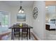Dining room with a modern chandelier and rustic table set at 317 Annatto Way, Tega Cay, SC 29708