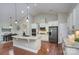 Bright kitchen has stainless appliances, hardwood floors, and a granite countertop at 317 Annatto Way, Tega Cay, SC 29708