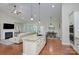 Open kitchen with a granite island, stainless steel appliances, and eat-in kitchen table at 317 Annatto Way, Tega Cay, SC 29708