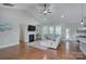 Bright living room features a fireplace, ceiling fan, and hardwood floors at 317 Annatto Way, Tega Cay, SC 29708