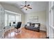 Office with hardwood floors, a comfortable sofa, and a bright bay window at 317 Annatto Way, Tega Cay, SC 29708