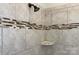 Close up of a tiled shower with a shower head and shower caddy at 317 Annatto Way, Tega Cay, SC 29708