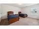 Bedroom with two beds, carpet, side tables, and ample natural light from window at 3512 Gibbon Terrace Ct, Charlotte, NC 28269