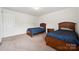 Bedroom featuring carpeted floor, twin beds, side table, and abundant natural light at 3512 Gibbon Terrace Ct, Charlotte, NC 28269
