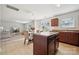 Open-concept kitchen and living area, featuring a kitchen island, dining table, and a cozy living room at 3512 Gibbon Terrace Ct, Charlotte, NC 28269