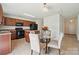 A modern kitchen and dining area showcasing wood cabinets, black appliances, and a dining set with four chairs at 3512 Gibbon Terrace Ct, Charlotte, NC 28269