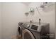 Functional laundry room with modern washer and dryer, plus organized shelving at 3512 Gibbon Terrace Ct, Charlotte, NC 28269
