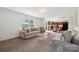 Open-concept living room boasts ample natural light and seamless flow to the dining area, perfect for gatherings at 3512 Gibbon Terrace Ct, Charlotte, NC 28269