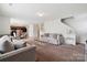 Inviting living room features neutral decor, comfortable seating, and adjacent dining area for easy entertaining at 3512 Gibbon Terrace Ct, Charlotte, NC 28269