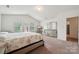 Well-lit main bedroom with vaulted ceiling, soft carpet, and calming tones, complemented by a modern dresser and lighting at 3512 Gibbon Terrace Ct, Charlotte, NC 28269