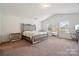 Spacious main bedroom with vaulted ceilings, plush carpeting, and a stylish bed with mirrored accents at 3512 Gibbon Terrace Ct, Charlotte, NC 28269