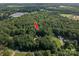 Aerial view showcasing a secluded home and pool nestled among lush trees, offering privacy and tranquility at 3513 Briarcliff Acres Dr, Lincolnton, NC 28092