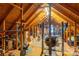 Attic features exposed wood beams, functional ceiling fan, and a dedicated workout area with exercise equipment at 3513 Briarcliff Acres Dr, Lincolnton, NC 28092