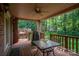 Covered back porch with ceiling fan overlooking a backyard and wooded area at 3513 Briarcliff Acres Dr, Lincolnton, NC 28092