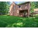 Brick house with a well-maintained backyard, porch, and surrounding mature trees at 3513 Briarcliff Acres Dr, Lincolnton, NC 28092