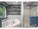 Bathroom features a soaking tub and glass enclosed shower with wood accent wall at 3513 Briarcliff Acres Dr, Lincolnton, NC 28092