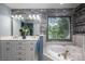Contemporary bathroom featuring a deep soaking tub, double vanity and modern finishes at 3513 Briarcliff Acres Dr, Lincolnton, NC 28092