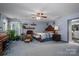 Spacious bedroom with a ceiling fan, large window with plants, and access to the en suite bath at 3513 Briarcliff Acres Dr, Lincolnton, NC 28092