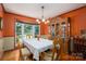 Formal dining room with wood floors, chandelier, and large window overlooking backyard at 3513 Briarcliff Acres Dr, Lincolnton, NC 28092