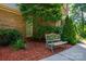 Inviting front exterior with a bench seat situated within lush landscaping with mulch at 3513 Briarcliff Acres Dr, Lincolnton, NC 28092