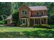 Lovely brick two-story home with lush green lawn and manicured landscaping and shrubs at 3513 Briarcliff Acres Dr, Lincolnton, NC 28092