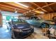 Spacious garage interior features wood beams, ample lighting, and room for a car and pickup truck at 3513 Briarcliff Acres Dr, Lincolnton, NC 28092