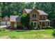 Charming two-story brick home boasts a well-manicured lawn, beautiful landscaping, and an inviting front porch at 3513 Briarcliff Acres Dr, Lincolnton, NC 28092