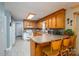 Functional kitchen with oak cabinets, laminate countertops, and breakfast bar seating at 3513 Briarcliff Acres Dr, Lincolnton, NC 28092