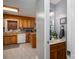 Traditional kitchen with oak cabinets and views into adjacent half bathroom at 3513 Briarcliff Acres Dr, Lincolnton, NC 28092