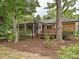 Charming brick home featuring a wooden deck and screened-in porch, nestled in a lush, tree-filled backyard at 4000 Chandworth Rd, Charlotte, NC 28210