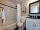 Updated bathroom with marble tiled walls, black accents, tub and shower at 4000 Chandworth Rd, Charlotte, NC 28210