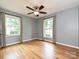 Spacious bedroom with wood floors and lots of natural light from the two bright windows at 4000 Chandworth Rd, Charlotte, NC 28210