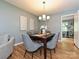 Cozy dining room featuring modern lighting and a dark wood table set for six guests at 4000 Chandworth Rd, Charlotte, NC 28210
