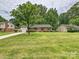 Charming brick home with a well-manicured lawn and mature trees in a desirable location at 4000 Chandworth Rd, Charlotte, NC 28210