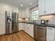 Updated kitchen with stainless steel appliances, white cabinets, granite countertops, and subway tile backsplash at 4000 Chandworth Rd, Charlotte, NC 28210