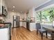 Bright kitchen with stainless steel appliances, white cabinets, breakfast nook, and a large window at 4000 Chandworth Rd, Charlotte, NC 28210