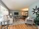 Bright living room featuring hardwood floors, neutral furniture, and a dining room view at 4000 Chandworth Rd, Charlotte, NC 28210